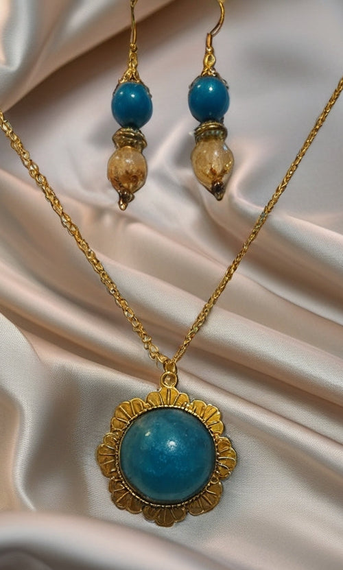 Gold necklace and earrings set with blue beads and blue pendant