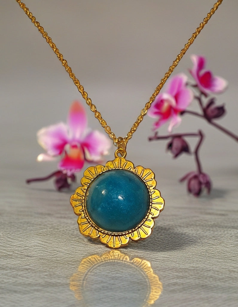 Gold necklace with blue pendant